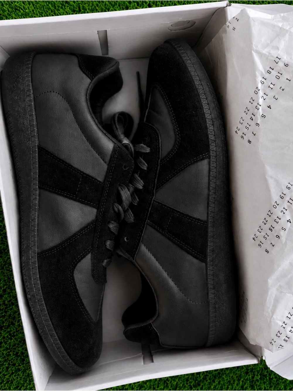 Black leather German Army trainer style sneakers.